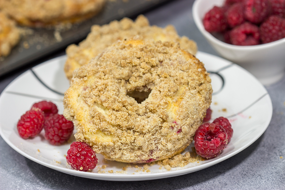 These baked Raspberry Crumb Donuts feature a cake-like base filled with fresh raspberries...and then topped with a thick layer of brown sugar crumble. They're delicious!