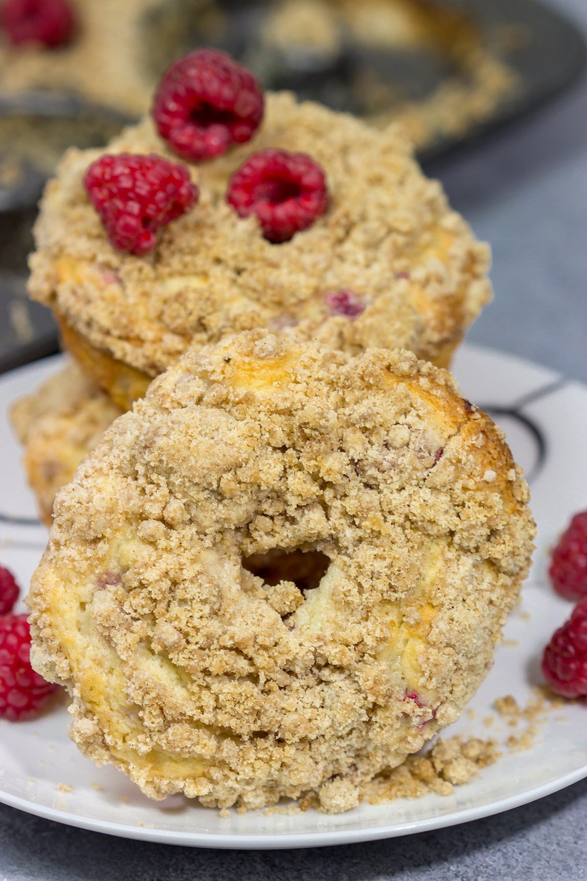 These baked Raspberry Crumb Donuts feature a cake-like base filled with fresh raspberries...and then topped with a thick layer of brown sugar crumble. They're delicious!