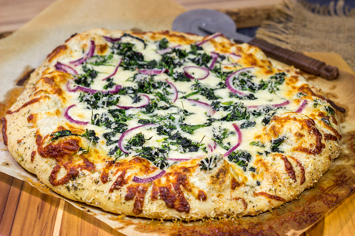 Mix up pizza night with this Spinach Ricotta Pizza! Using ricotta cheese for "sauce," this pizza is extra creamy...and extra delicious!