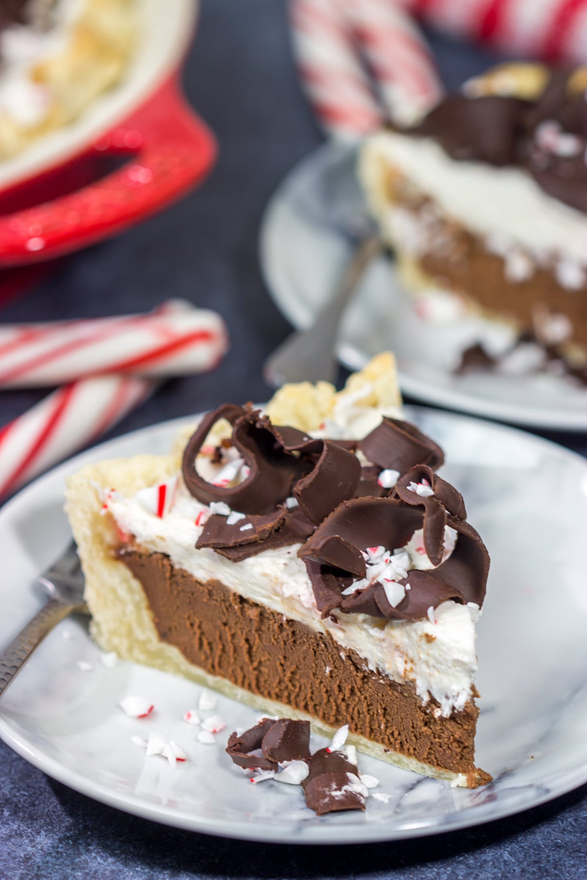 Topped with creamy whipped cream and large chocolate curls, this Chocolate Peppermint Pie is a tasty and impressive dessert to serve during the holiday season!