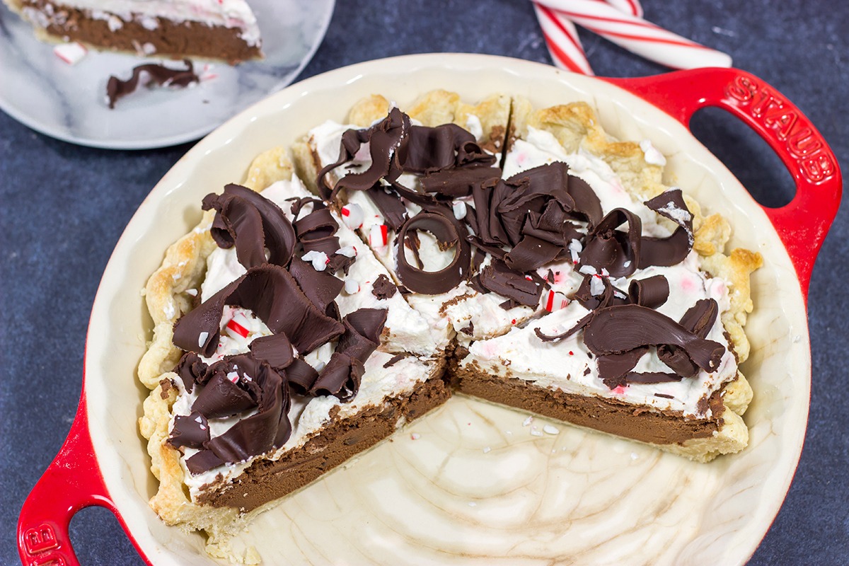 Topped with creamy whipped cream and large chocolate curls, this Chocolate Peppermint Pie is a tasty and impressive dessert to serve during the holiday season!