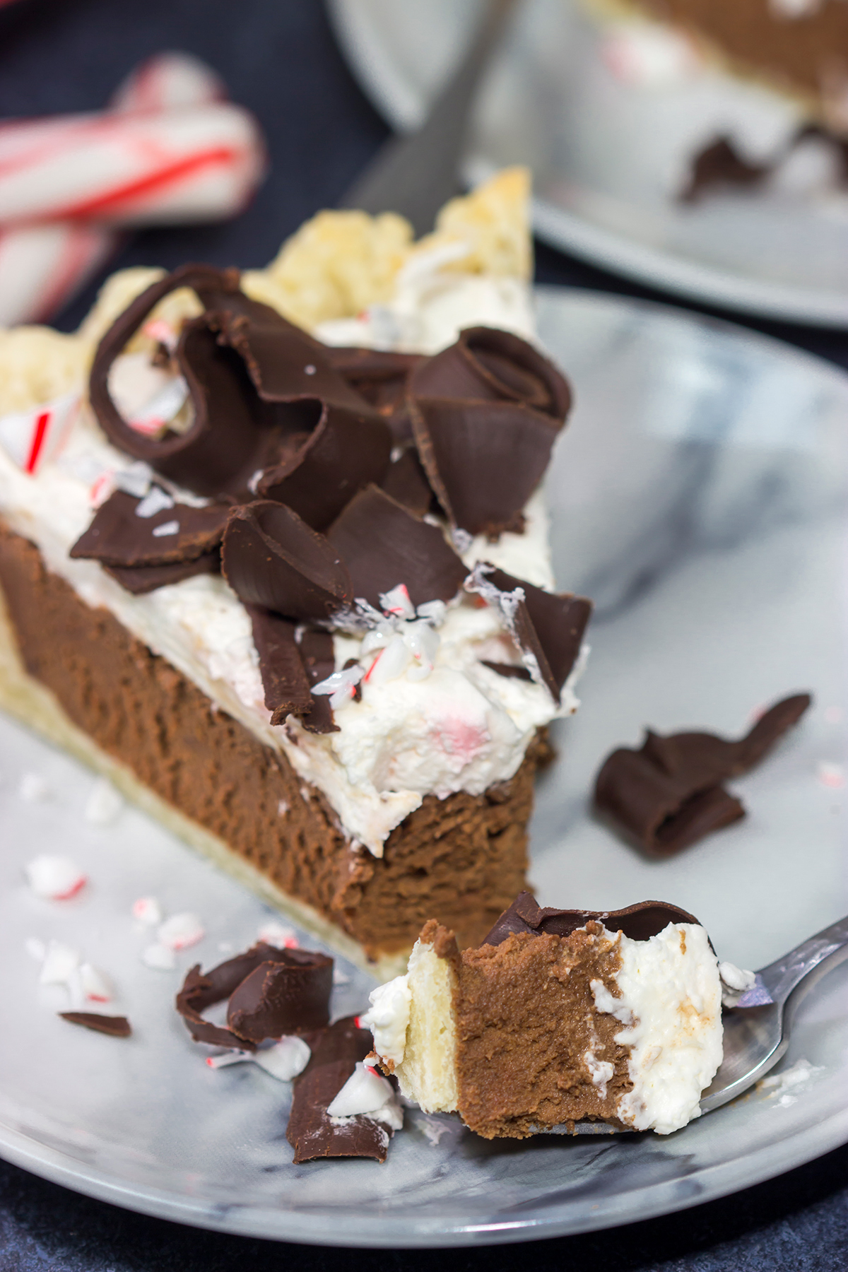 Topped with creamy whipped cream and large chocolate curls, this Chocolate Peppermint Pie is a tasty and impressive dessert to serve during the holiday season!