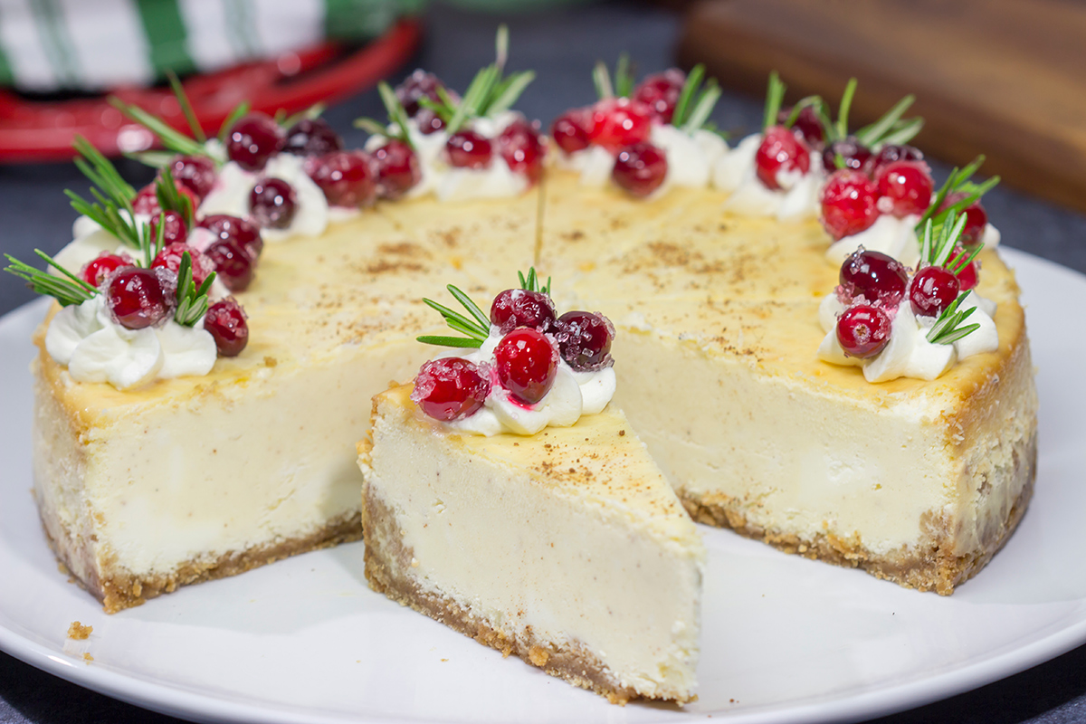 Topped with sugared cranberries and eggnog whipped cream, this Eggnog Cheesecake is a festive way to celebrate the holiday season!