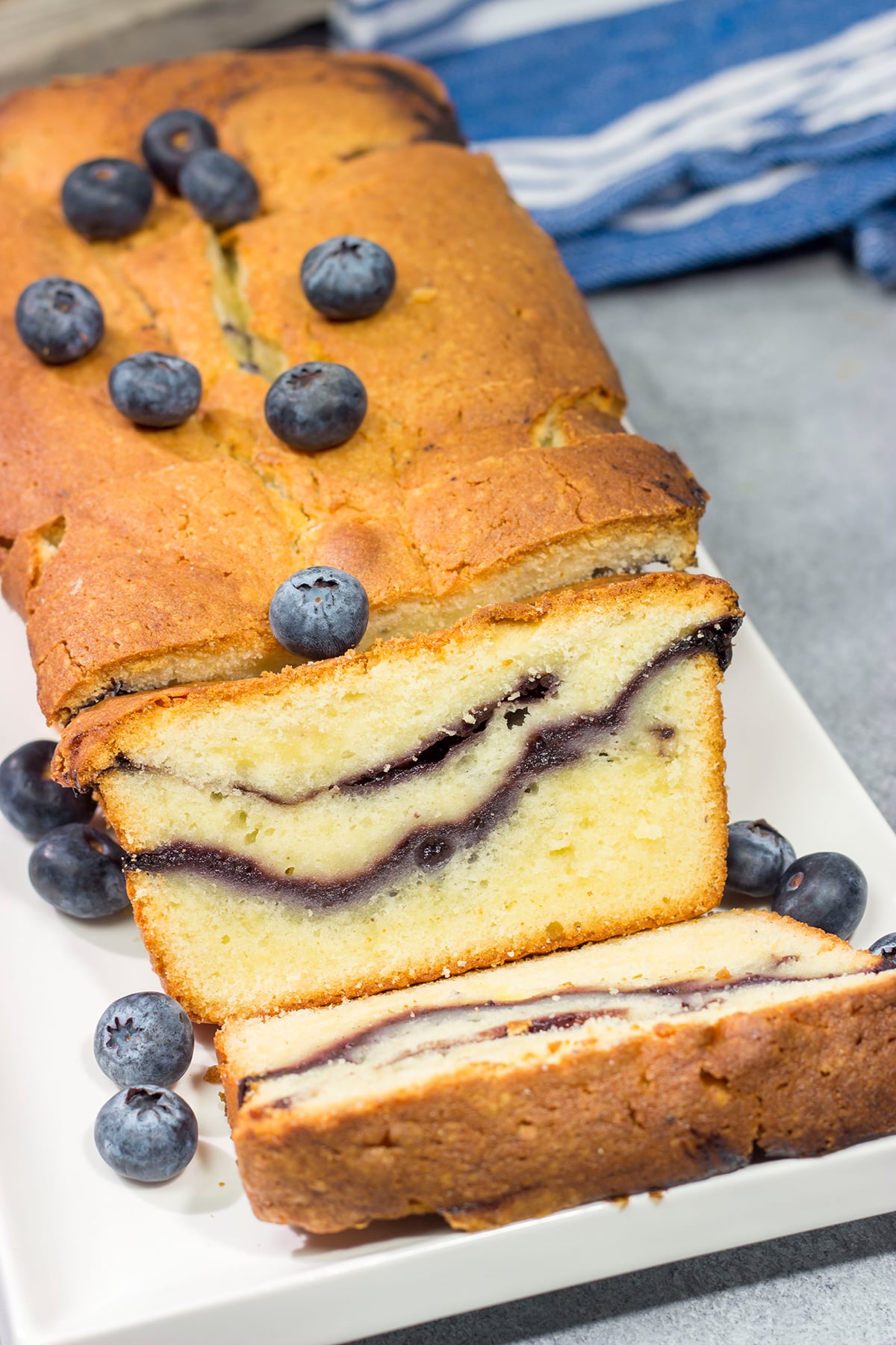 Featuring a ribbon of blueberry sauce swirled into the cake, this Blueberry Cream Cheese Pound Cake is a fun and tasty treat! Bake one today!