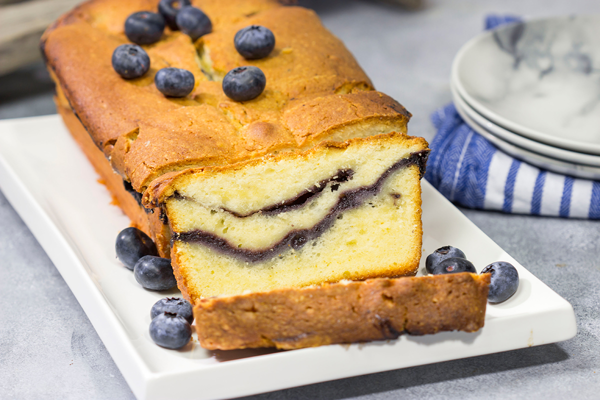 Featuring a ribbon of blueberry sauce swirled into the cake, this Blueberry Cream Cheese Pound Cake is a fun and tasty treat! Bake one today!
