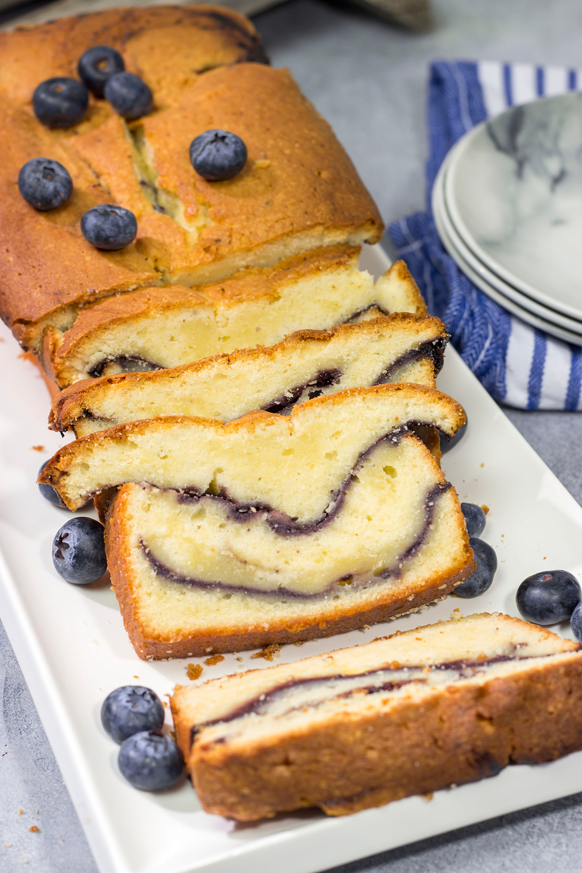 Featuring a ribbon of blueberry sauce swirled into the cake, this Blueberry Cream Cheese Pound Cake is a fun and tasty treat! Bake one today!