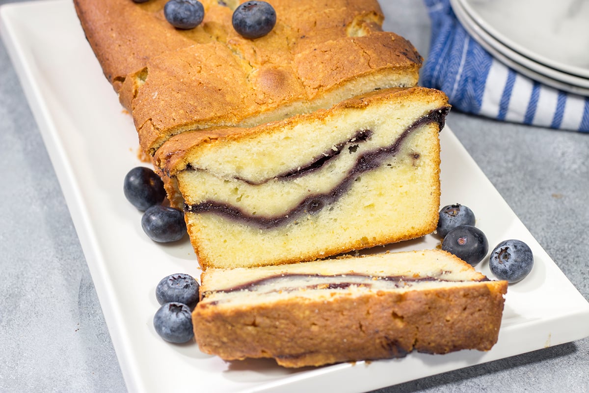 Featuring a ribbon of blueberry sauce swirled into the cake, this Blueberry Cream Cheese Pound Cake is a fun and tasty treat! Bake one today!