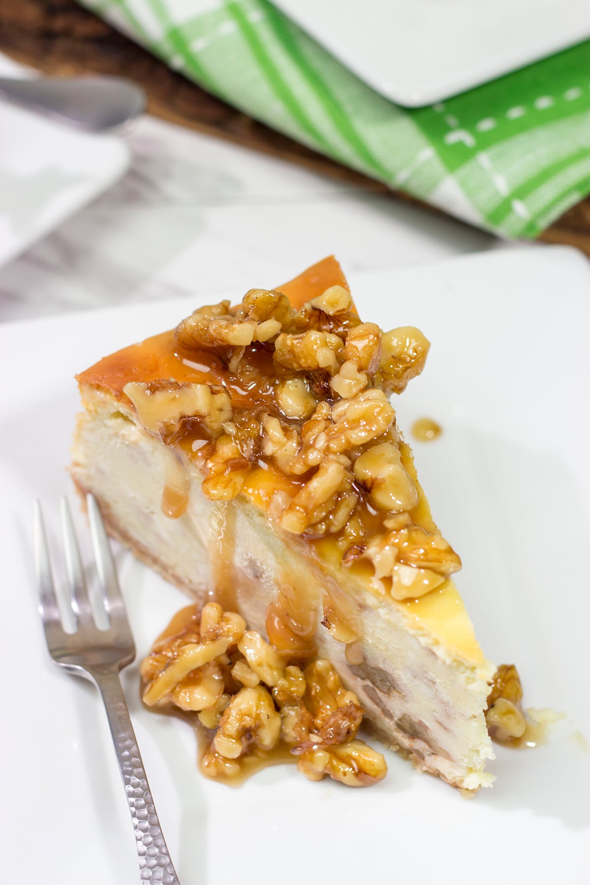 Featuring a warm honey walnut topping on top of a classic cheesecake, a slice of this Honey Walnut Cheesecake is a great way to end the day!