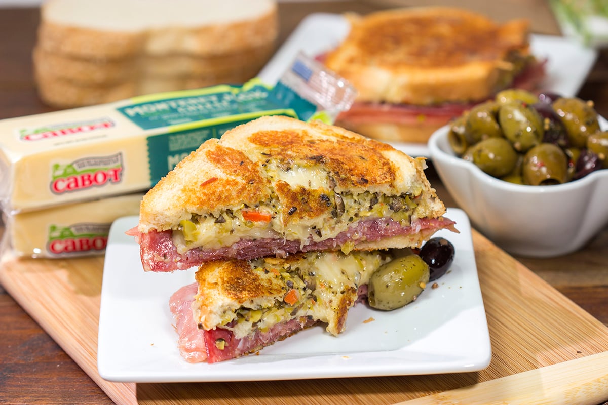 Celebrate National Grilled Cheese Month with a New Orleans flare! This Muffaletta Grilled Cheese sandwich combines two favorites into one!