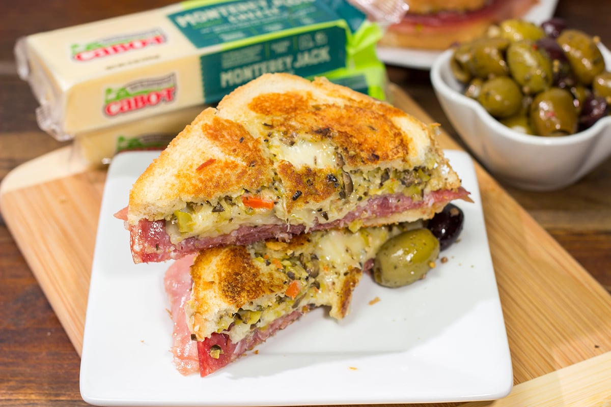 Celebrate National Grilled Cheese Month with a New Orleans flare! This Muffaletta Grilled Cheese sandwich combines two favorites into one!