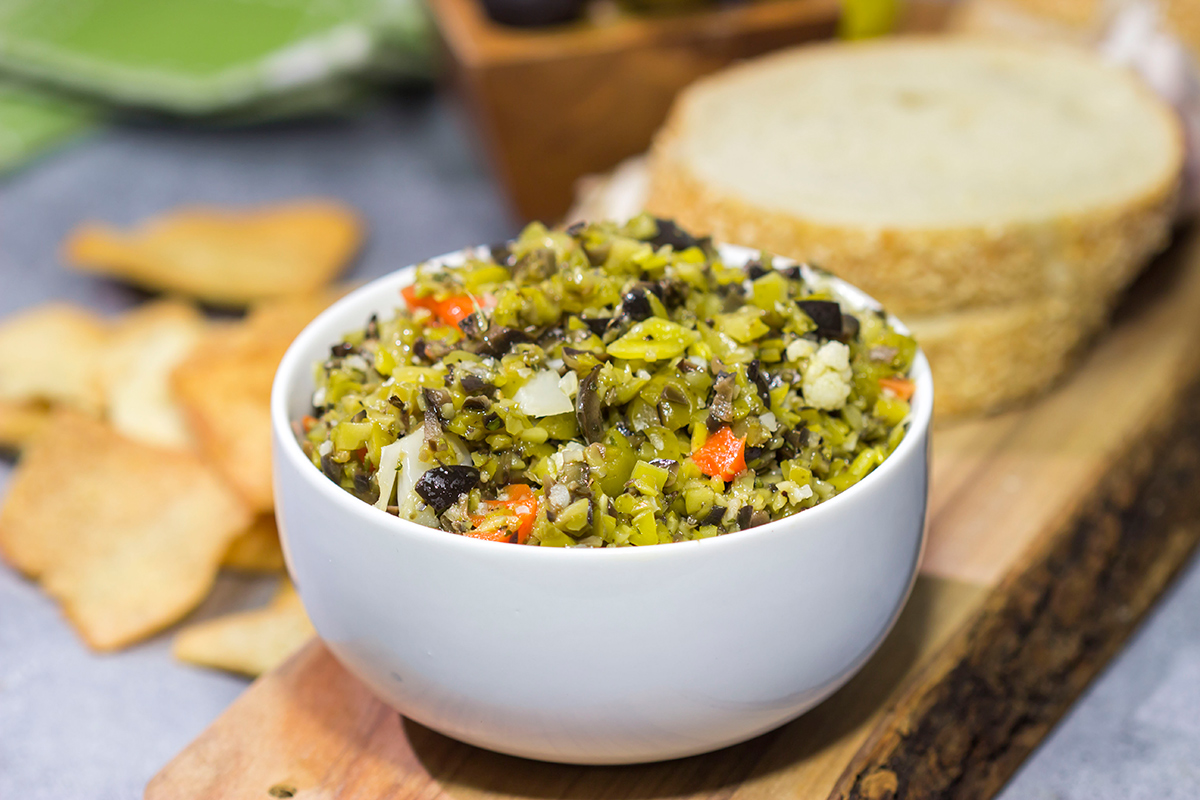 Often used in the classic New Orleans sandwich, a good Muffaletta Olive Salad is delicious in its own right. Spread it on top of grilled chicken or serve with pita chips as a dip!