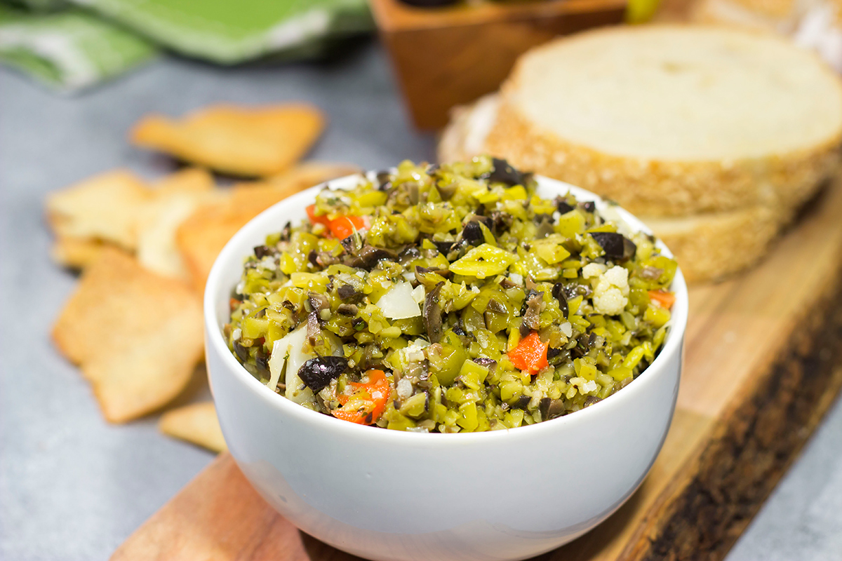 Often used in the classic New Orleans sandwich, a good Muffaletta Olive Salad is delicious in its own right. Spread it on top of grilled chicken or serve with pita chips as a dip!