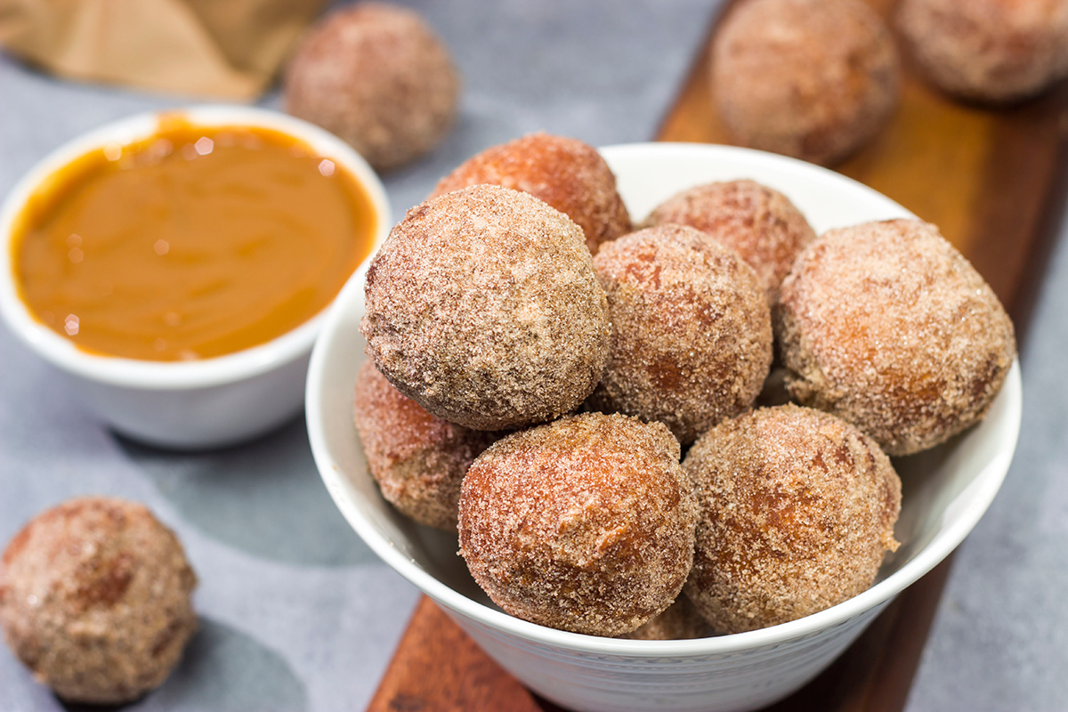 Served with homemade dulce de leche for dipping, these Snickerdoodle Donut Holes are packed with cinnamon sugar flavor!