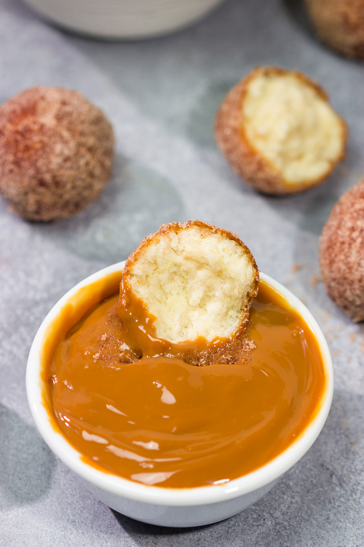 Served with homemade dulce de leche for dipping, these Snickerdoodle Donut Holes are packed with cinnamon sugar flavor!