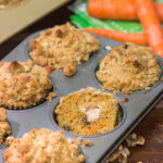 These Stuffed Carrot Cake Muffins feature tasty carrot cake muffins topped with brown sugar + walnut streusel...and stuffed with a dollop of cream cheese frosting!