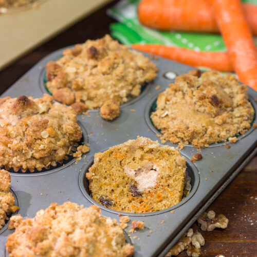 These Stuffed Carrot Cake Muffins feature tasty carrot cake muffins topped with brown sugar + walnut streusel...and stuffed with a dollop of cream cheese frosting!