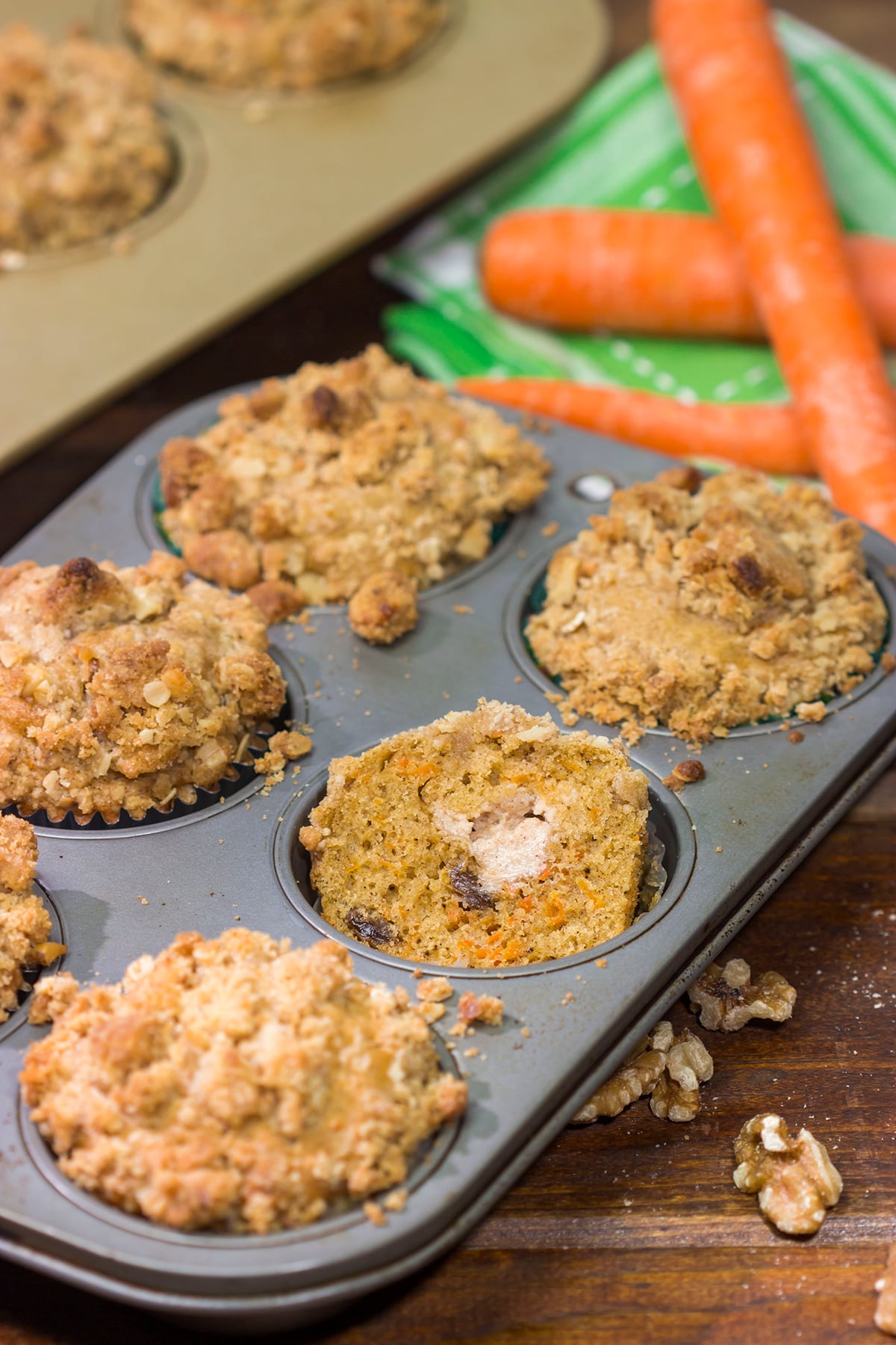 These Stuffed Carrot Cake Muffins feature tasty carrot cake muffins topped with brown sugar + walnut streusel...and stuffed with a dollop of cream cheese frosting!