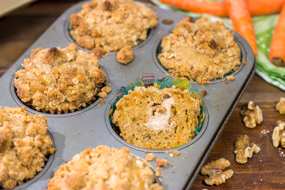 These Stuffed Carrot Cake Muffins feature tasty carrot cake muffins topped with brown sugar + walnut streusel...and stuffed with a dollop of cream cheese frosting!