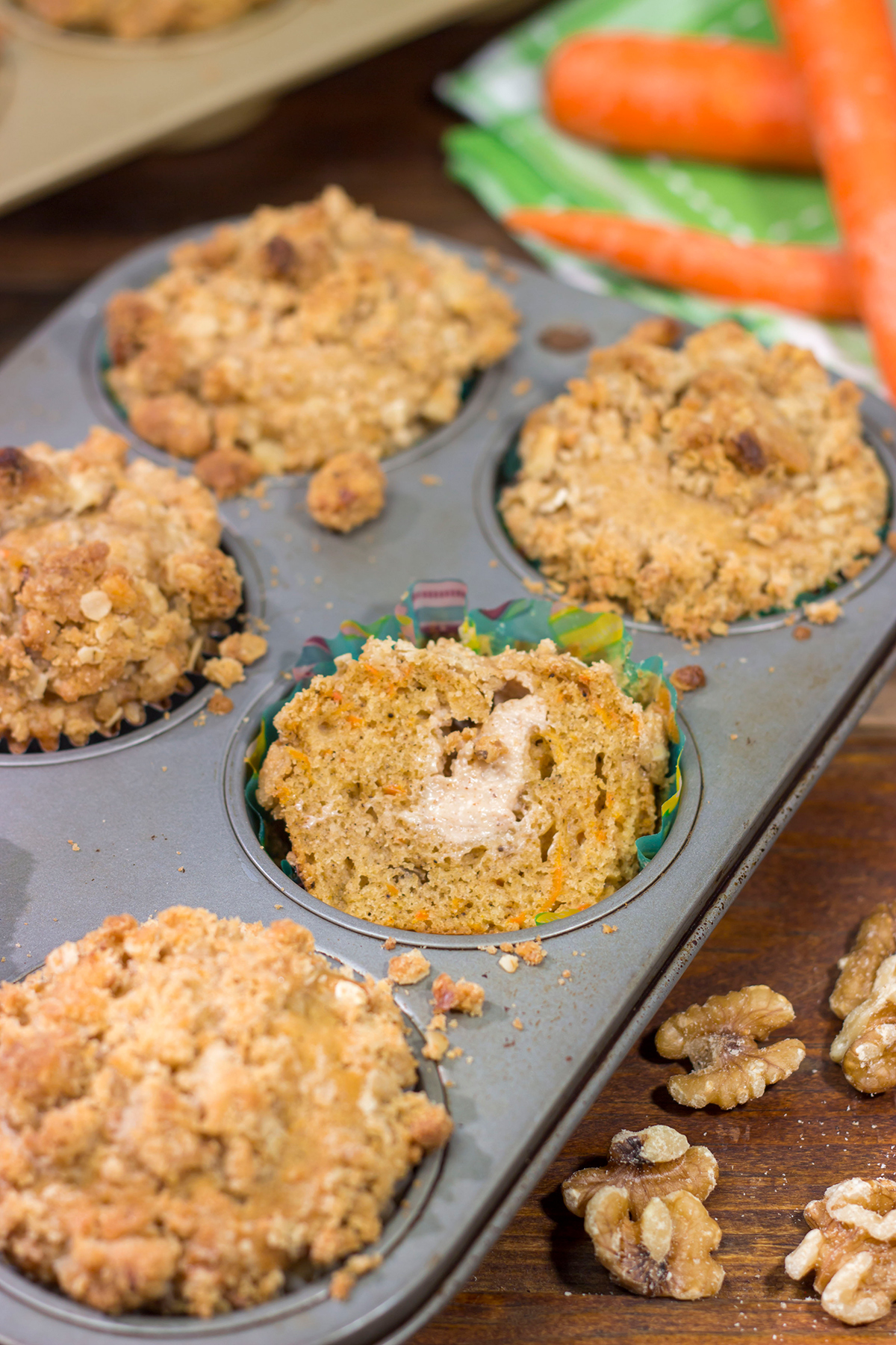 These Stuffed Carrot Cake Muffins feature tasty carrot cake muffins topped with brown sugar + walnut streusel...and stuffed with a dollop of cream cheese frosting!