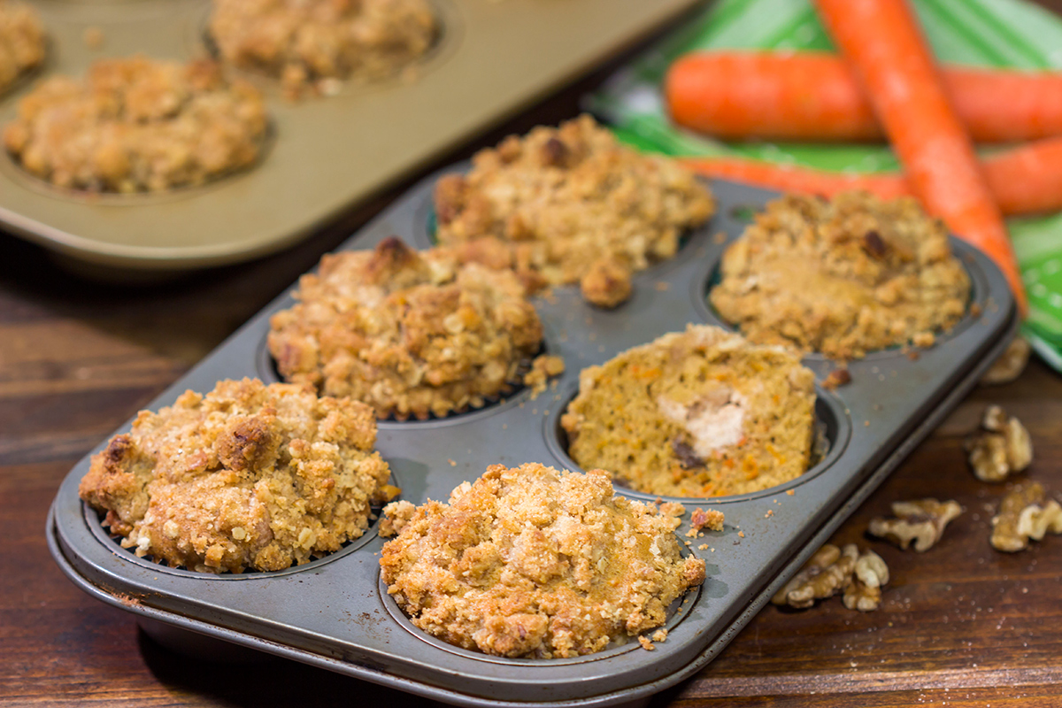 These Stuffed Carrot Cake Muffins feature tasty carrot cake muffins topped with brown sugar + walnut streusel...and stuffed with a dollop of cream cheese frosting!