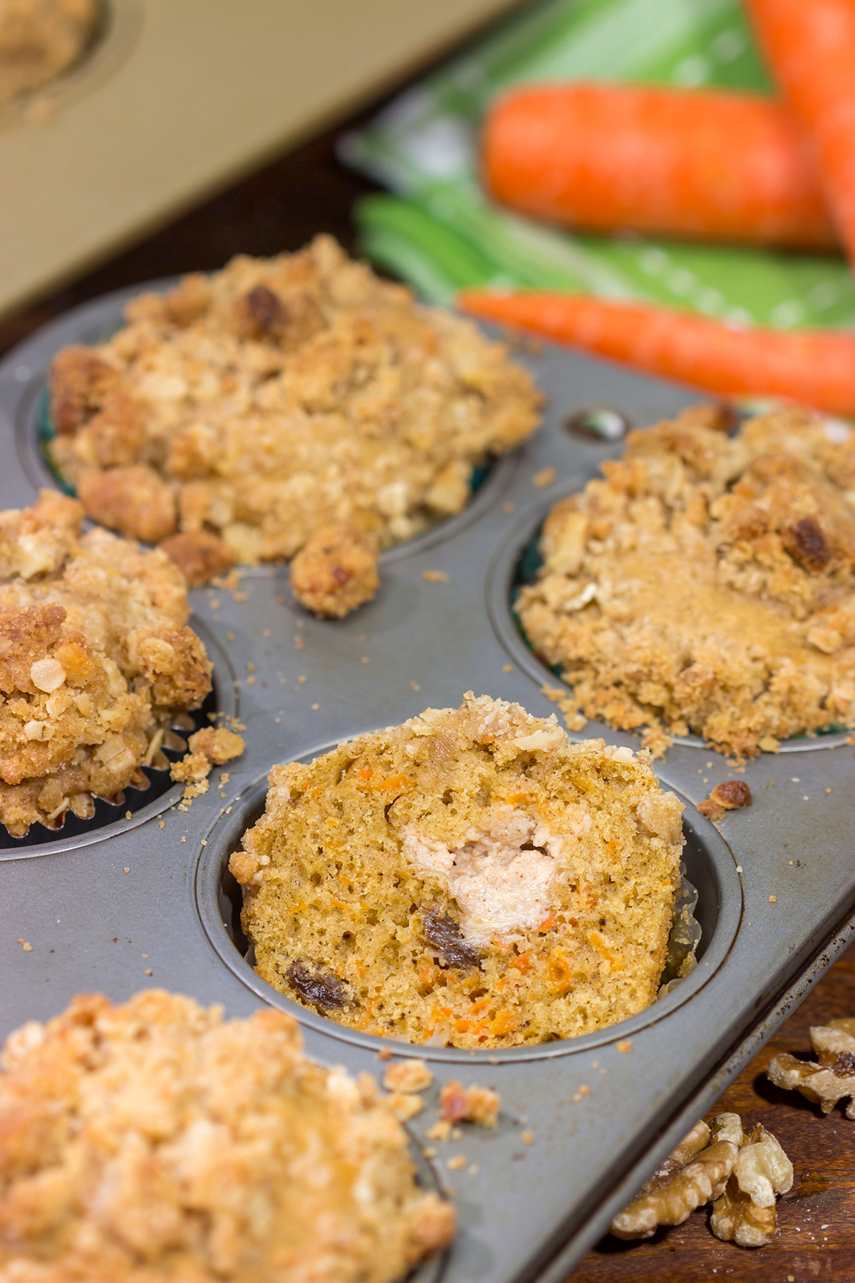 These Stuffed Carrot Cake Muffins feature tasty carrot cake muffins topped with brown sugar + walnut streusel...and stuffed with a dollop of cream cheese frosting!