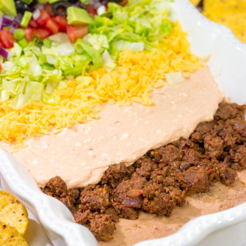 Featuring 10 layers of deliciousness, this Taco Salad Dip is a classic appetizer that is always a crowd pleaser!