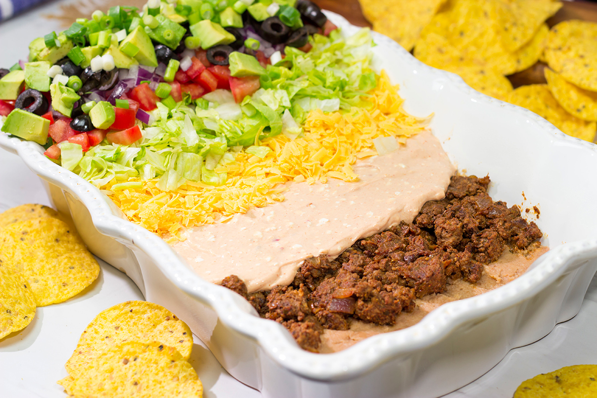 Featuring 10 layers of deliciousness, this Taco Salad Dip is a classic appetizer that is always a crowd pleaser!