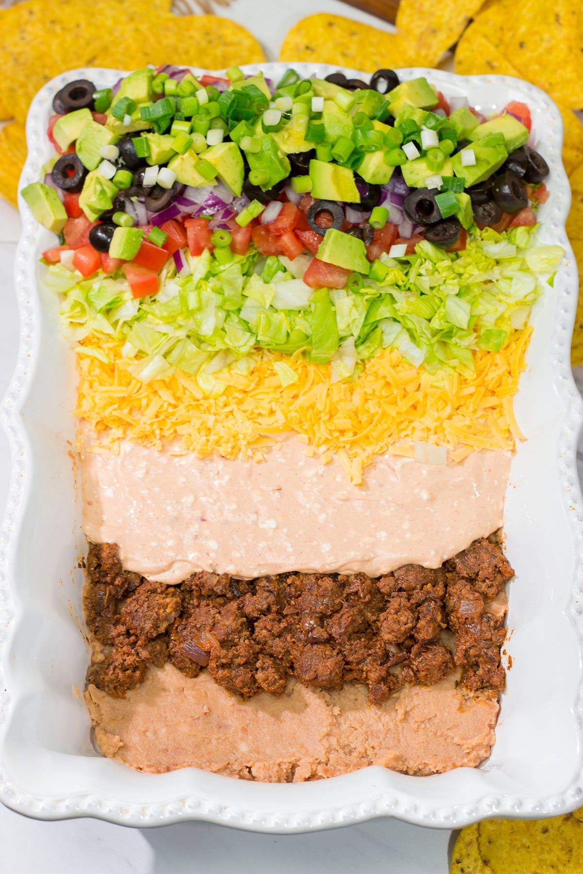 Featuring 10 layers of deliciousness, this Taco Salad Dip is a classic appetizer that is always a crowd pleaser!