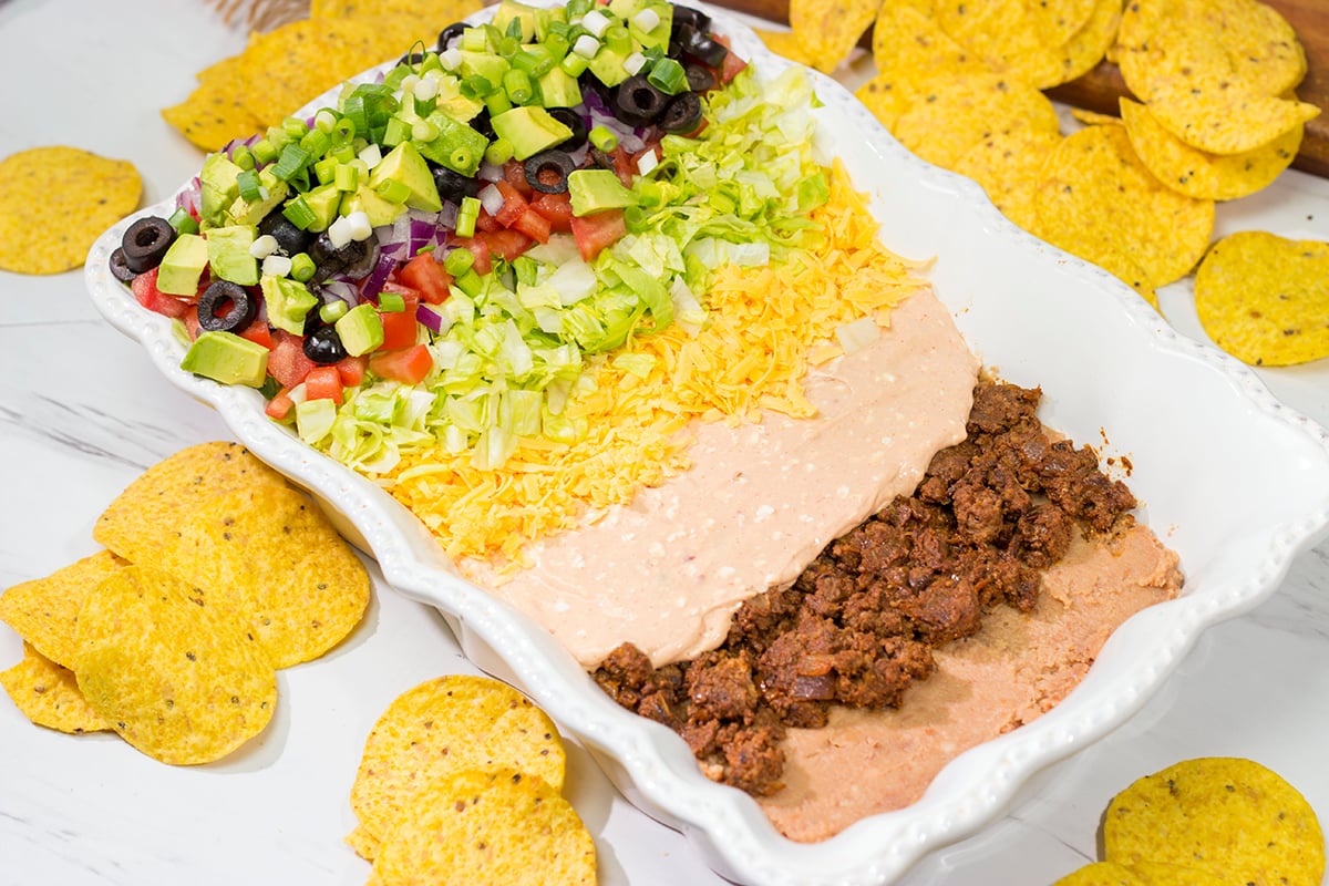 Featuring 10 layers of deliciousness, this Taco Salad Dip is a classic appetizer that is always a crowd pleaser!