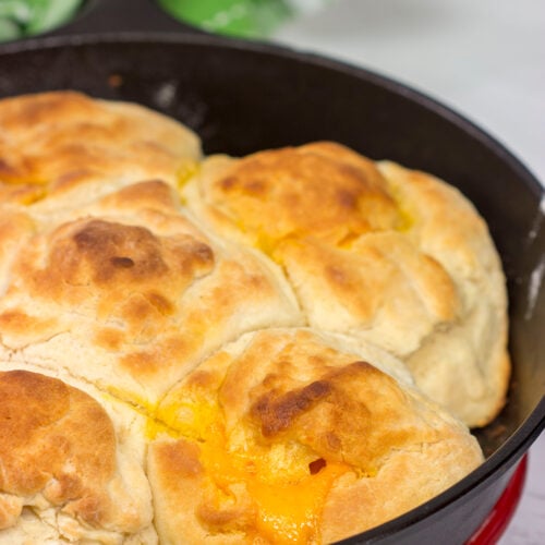 These North Carolina Cathead Biscuits are golden brown and buttery on the outside and soft and fluffy on the inside. Oh, and they're stuffed with cheese!