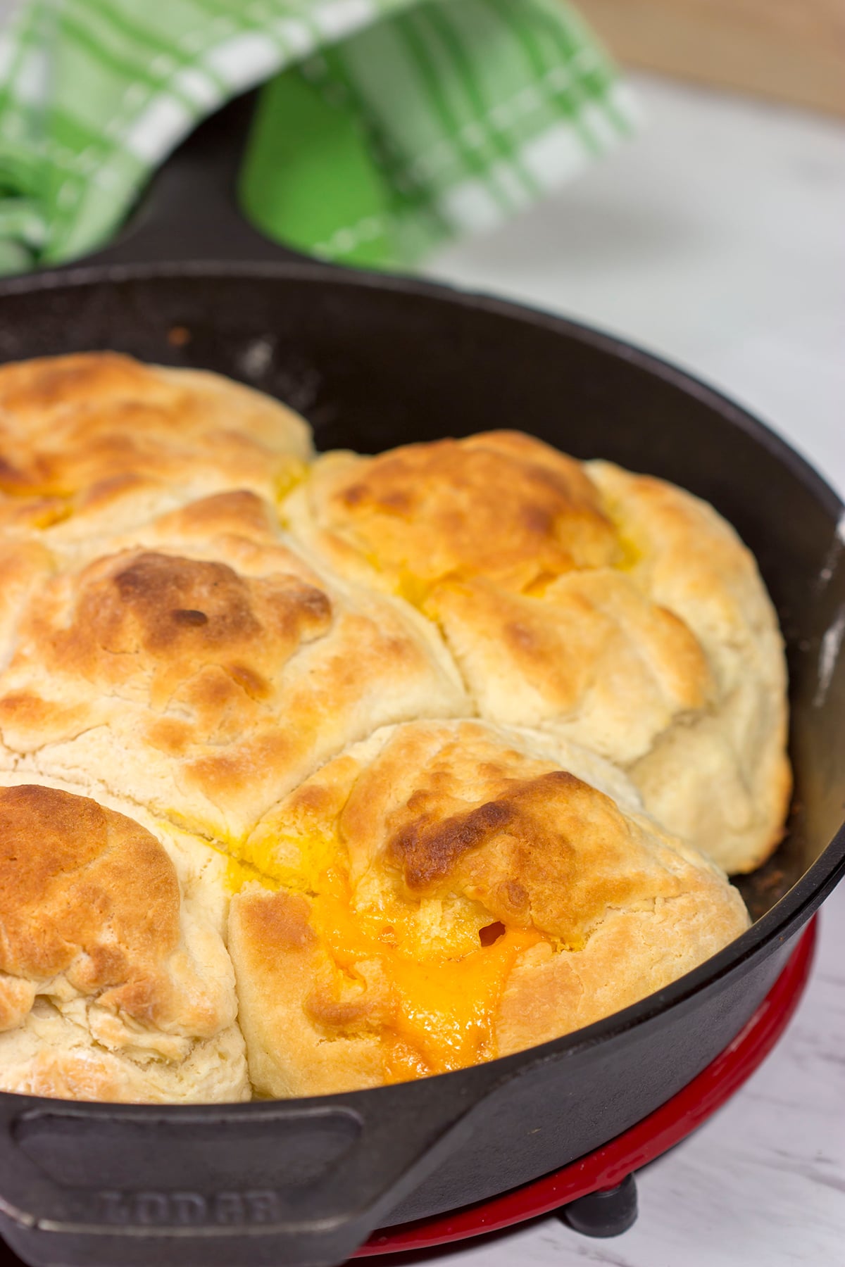 These North Carolina Cathead Biscuits are golden brown and buttery on the outside and soft and fluffy on the inside. Oh, and they're stuffed with cheese!