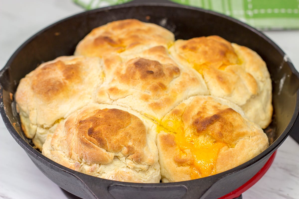 These North Carolina Cathead Biscuits are golden brown and buttery on the outside and soft and fluffy on the inside. Oh, and they're stuffed with cheese!