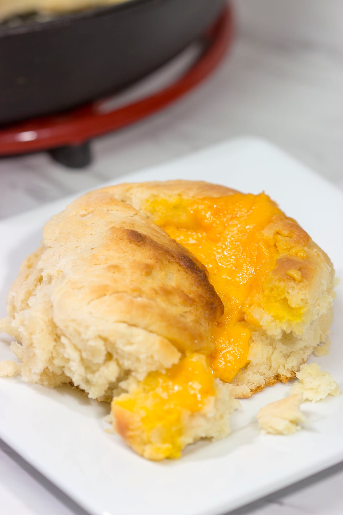 These North Carolina Cathead Biscuits are golden brown and buttery on the outside and soft and fluffy on the inside. Oh, and they're stuffed with cheese!