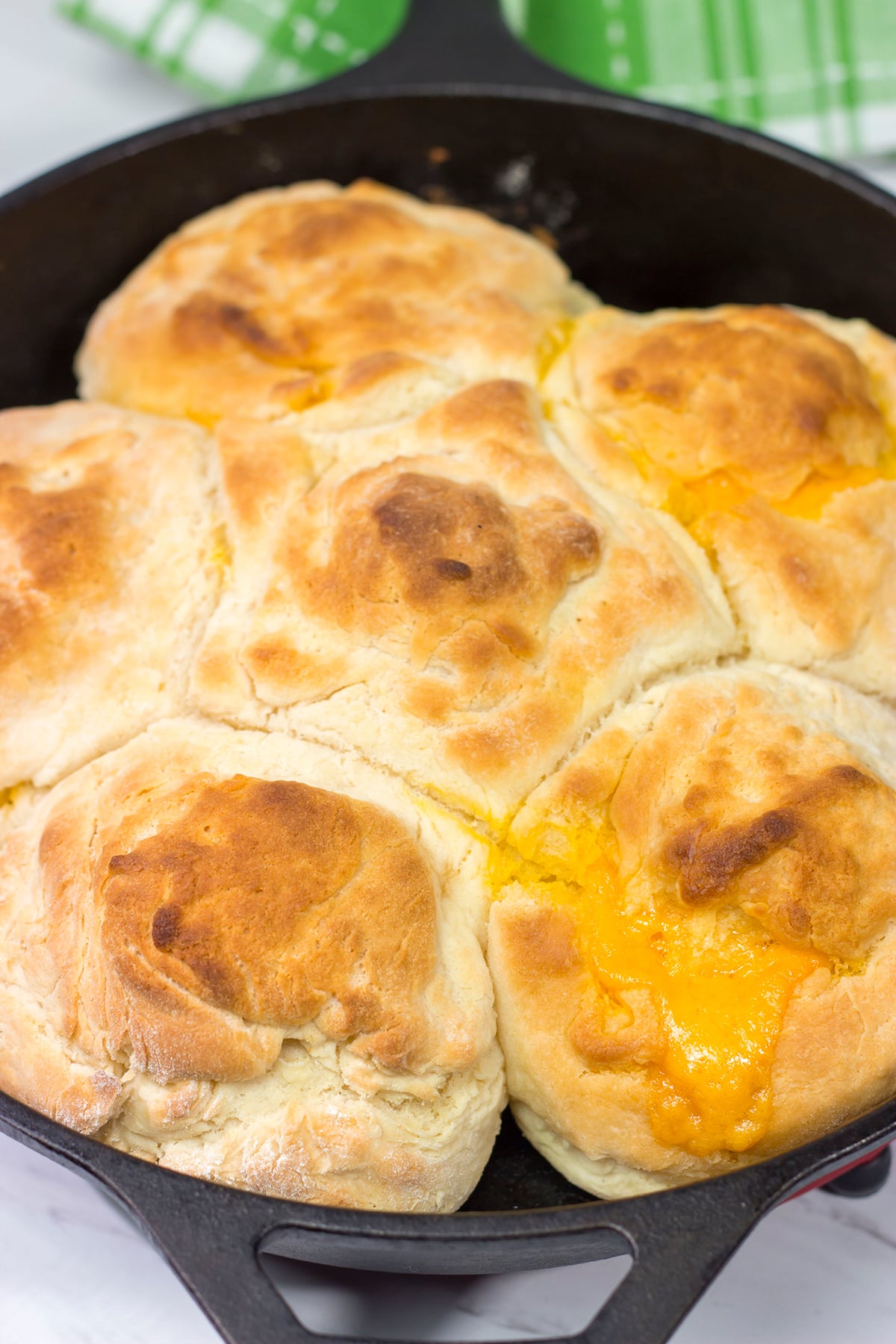 These North Carolina Cathead Biscuits are golden brown and buttery on the outside and soft and fluffy on the inside. Oh, and they're stuffed with cheese!