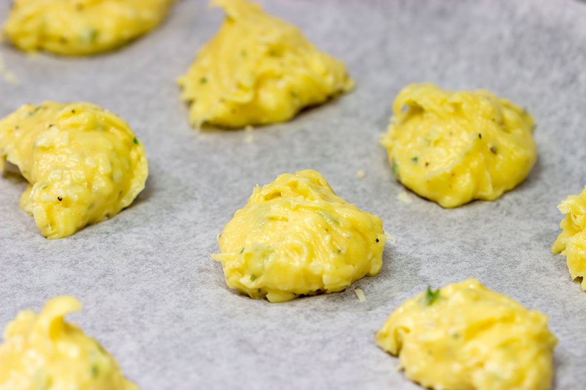 These Cheddar Cheese Puffs (also called Gougeres) are light and airy, and they melt in your mouth. They're great as an appetizer or served next to a bowl of soup!