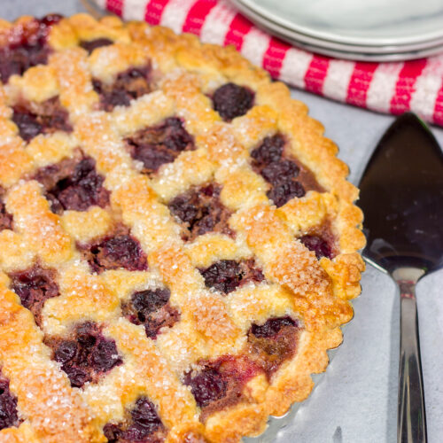 Featuring a sweetened crust that is a cross between shortbread cookie and pie dough, this Sour Cherry Crostata is a delicious dessert for a warm summer day!