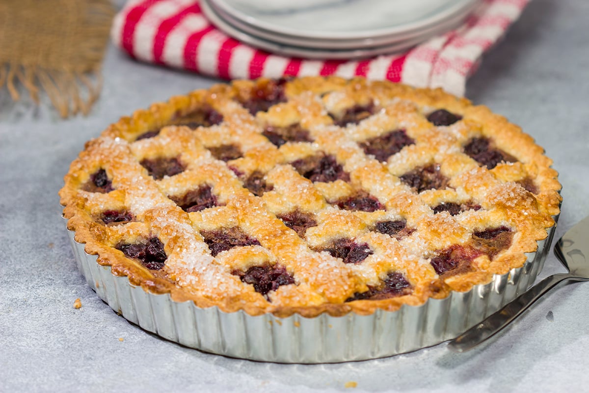 Featuring a sweetened crust that is a cross between shortbread cookie and pie dough, this Sour Cherry Crostata is a delicious dessert for a warm summer day!