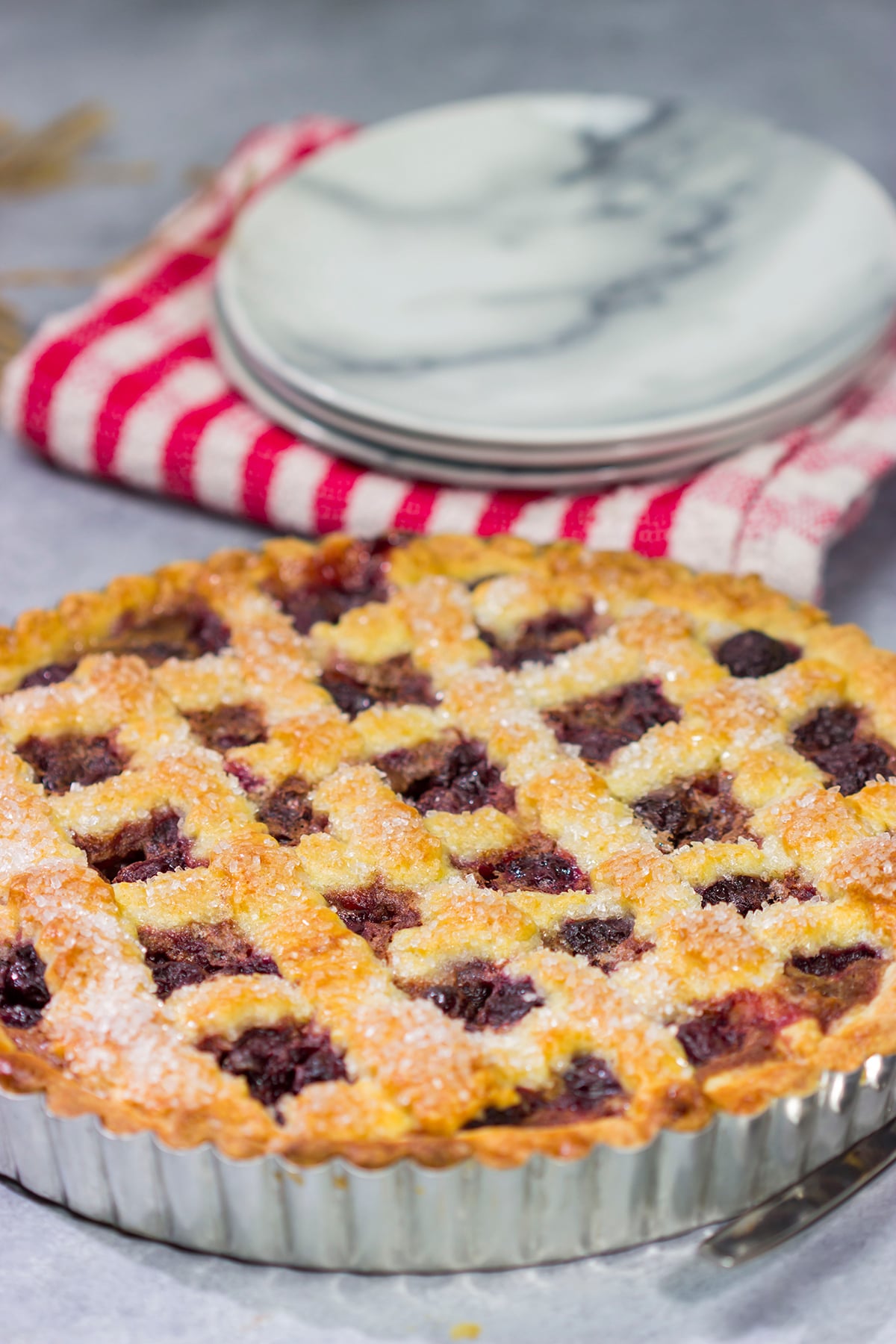 Featuring a sweetened crust that is a cross between shortbread cookie and pie dough, this Sour Cherry Crostata is a delicious dessert for a warm summer day!