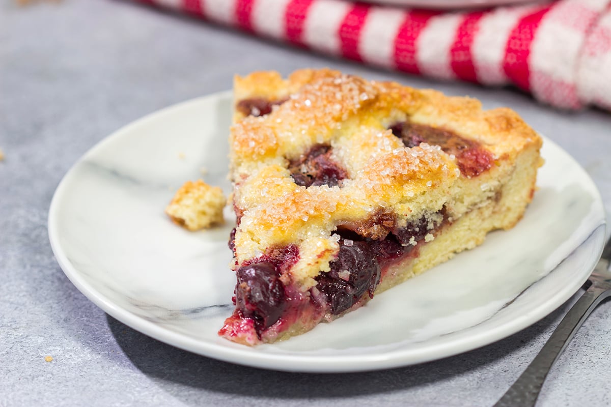 Featuring a sweetened crust that is a cross between shortbread cookie and pie dough, this Sour Cherry Crostata is a delicious dessert for a warm summer day!