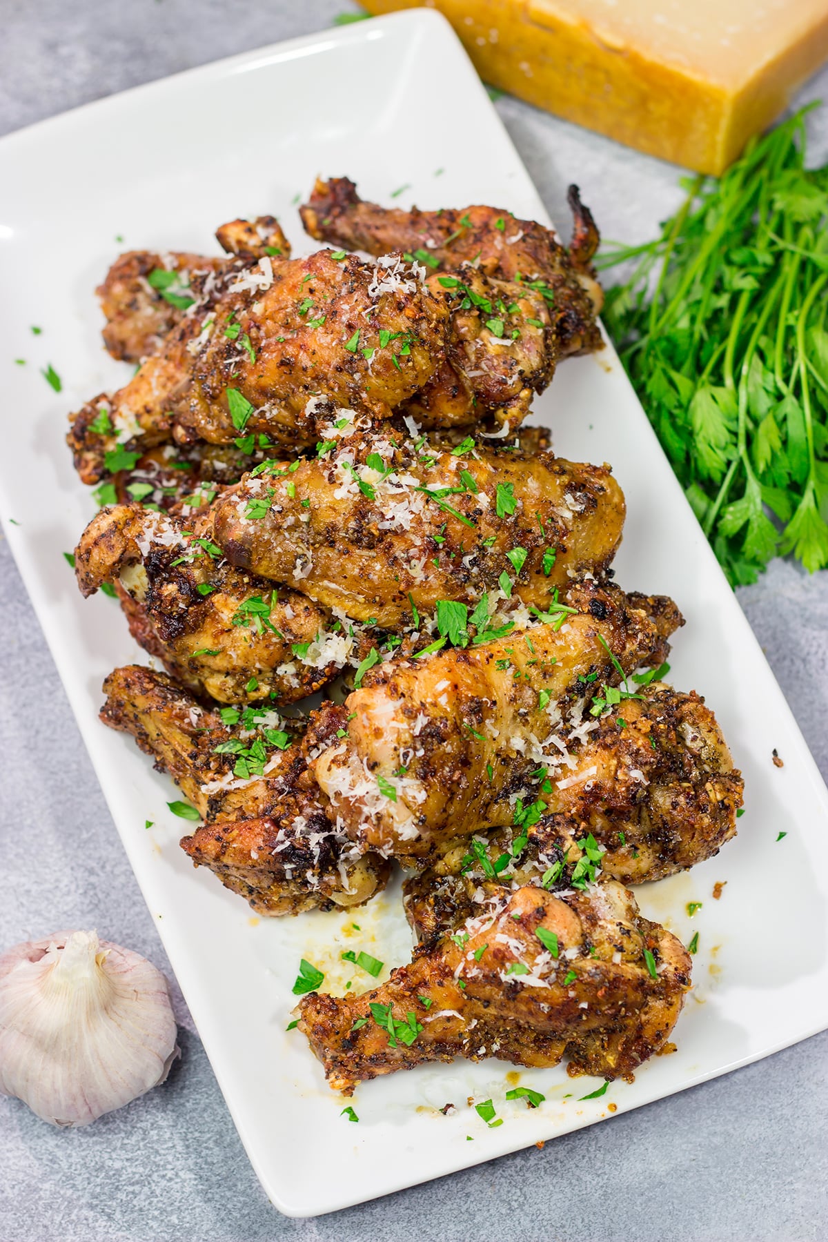 Fire up the grill! These Grilled Garlic Parmesan Chicken Wings are juicy and delicious. Add in the smoky grill flavor, and these grilled wings are perfect for a summer meal!