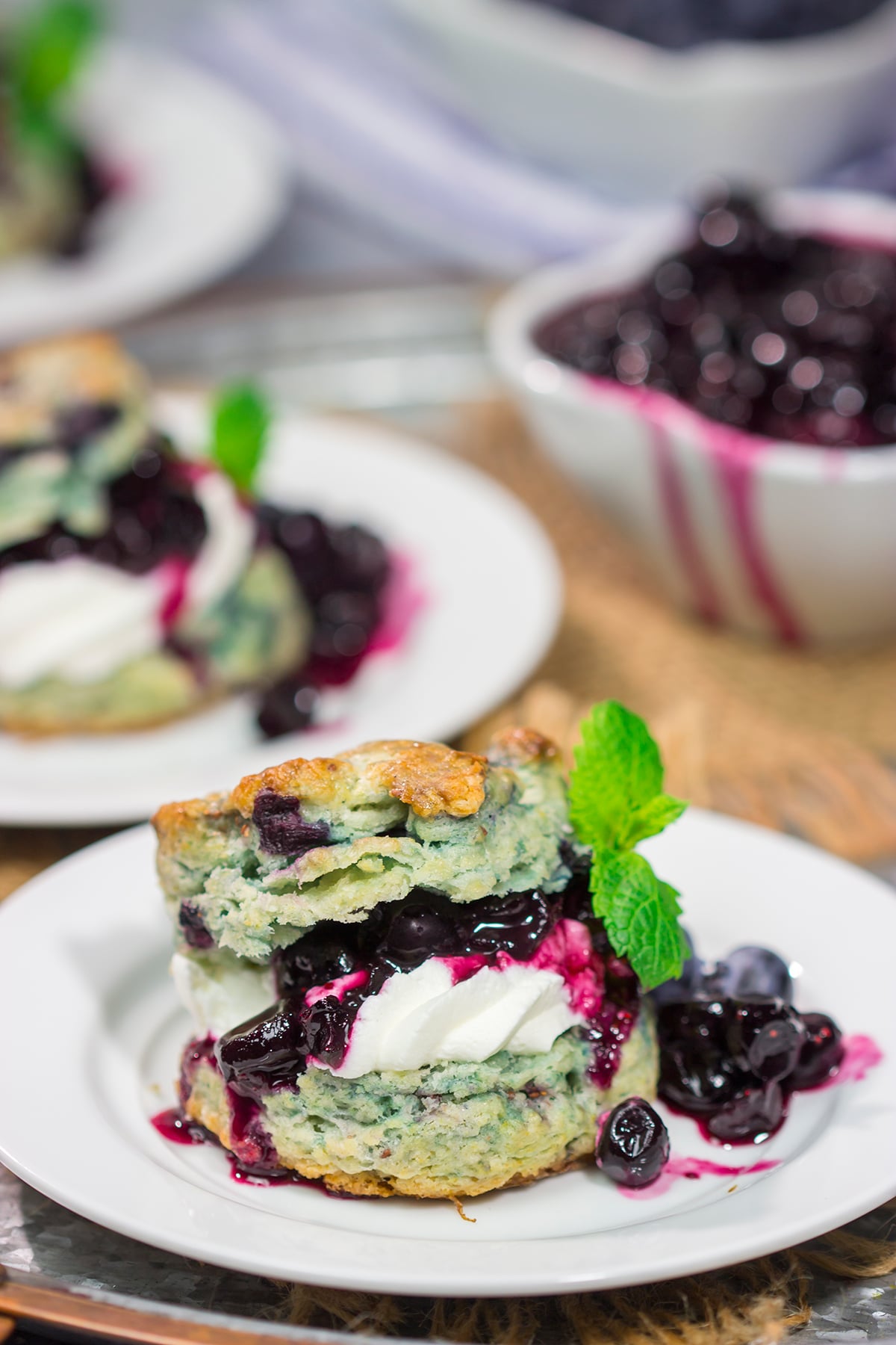 These Blueberry Shortcakes feature buttery biscuits filled with whipped cream and blueberry sauce. This recipe is great for summer brunch or dessert!