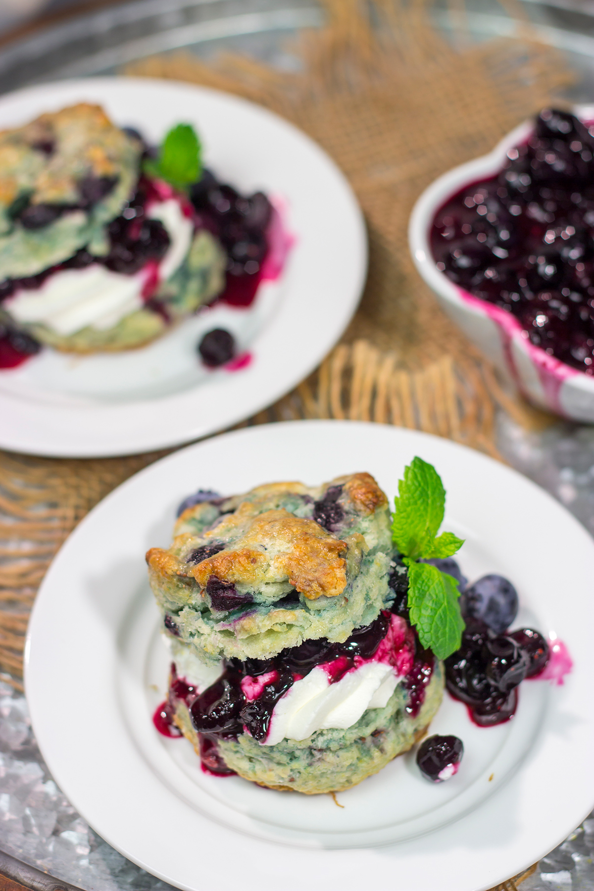 These Blueberry Shortcakes feature buttery biscuits filled with whipped cream and blueberry sauce. This recipe is great for summer brunch or dessert!