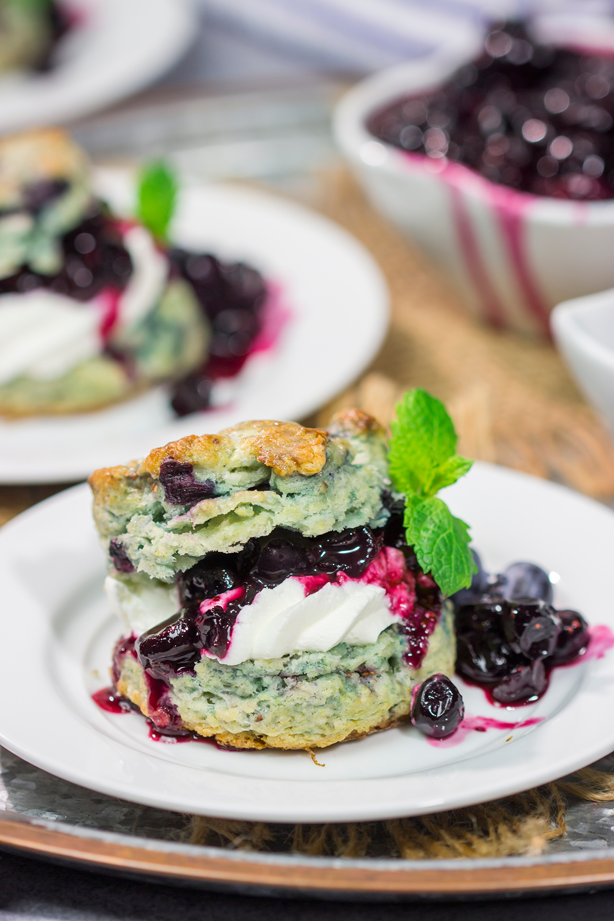 These Blueberry Shortcakes feature buttery biscuits filled with whipped cream and blueberry sauce. This recipe is great for summer brunch or dessert!
