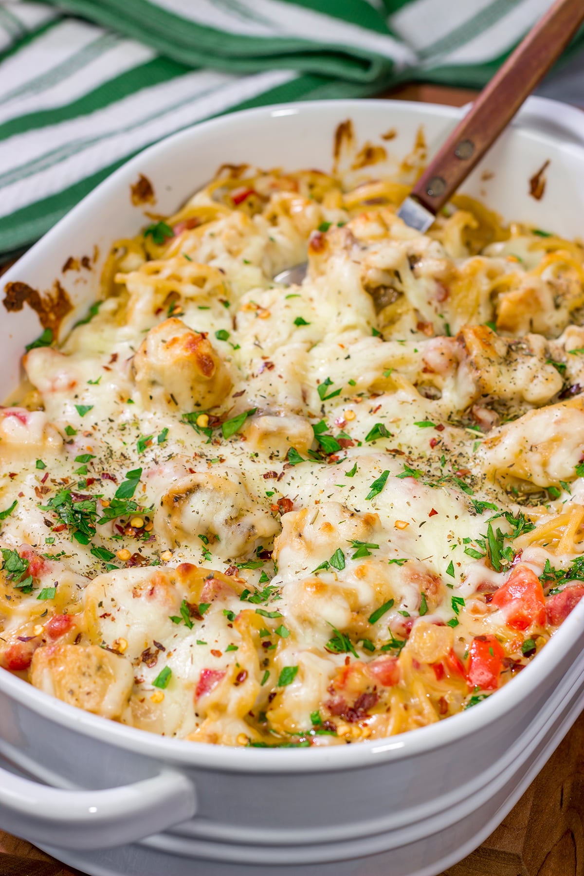 This Chicken Spaghetti features bite-sized pieces of tender chicken tossed in a creamy, cheesy sauce. This recipe is comfort food at its best!