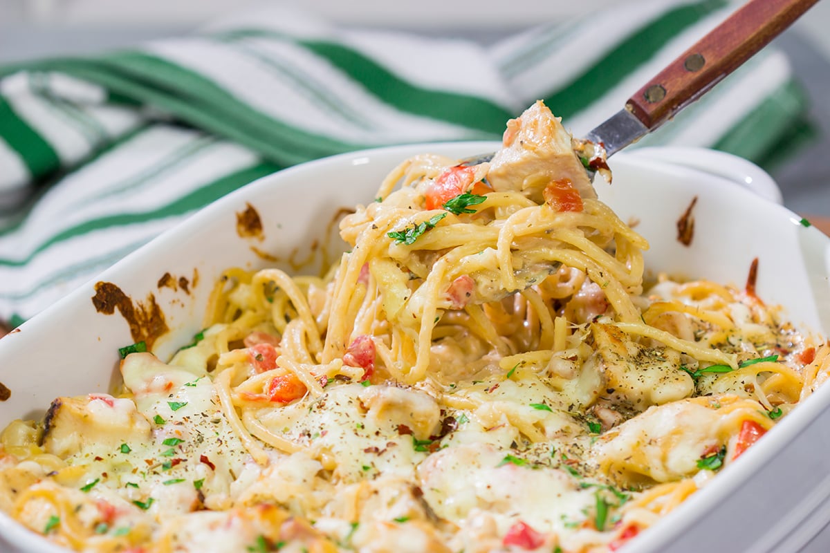 This Chicken Spaghetti features bite-sized pieces of tender chicken tossed in a creamy, cheesy sauce. This recipe is comfort food at its best!