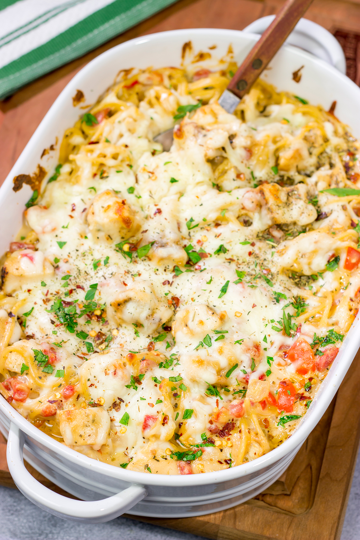 This Chicken Spaghetti features bite-sized pieces of tender chicken tossed in a creamy, cheesy sauce. This recipe is comfort food at its best!