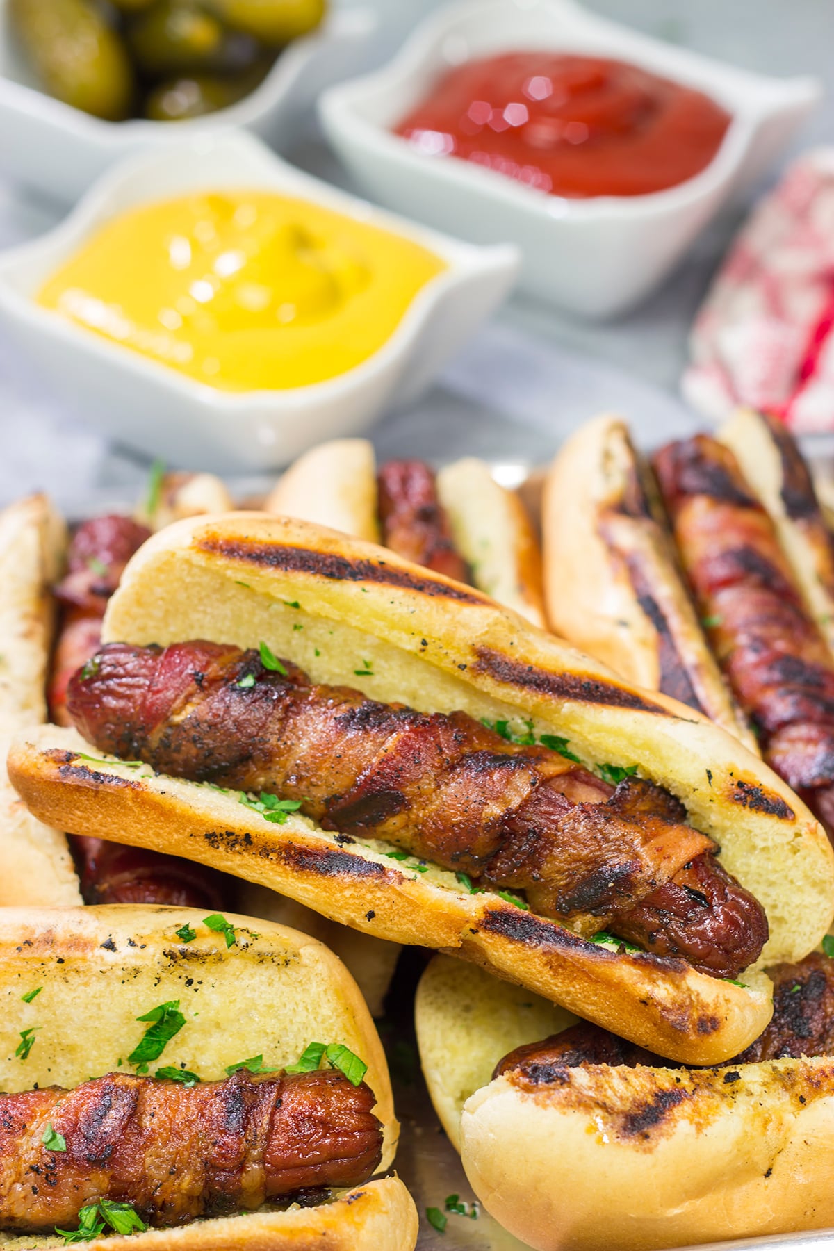 Holy hot dogs, Batman! No need for the oven here. These Grilled Bacon Wrapped Hot Dogs are cooked on the grill and served on a garlic bread buns. Yum!