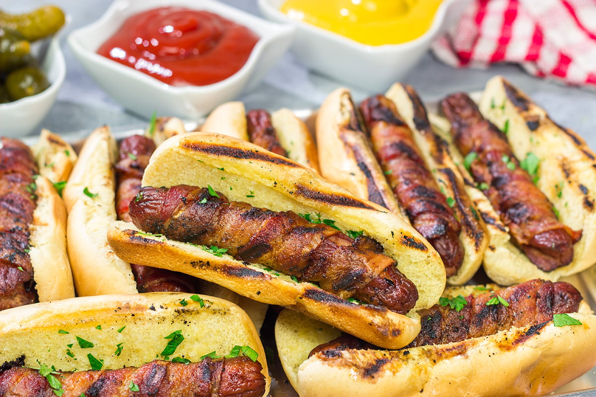 Holy hot dogs, Batman! No need for the oven here. These Grilled Bacon Wrapped Hot Dogs are cooked on the grill and served on a garlic bread buns. Yum!