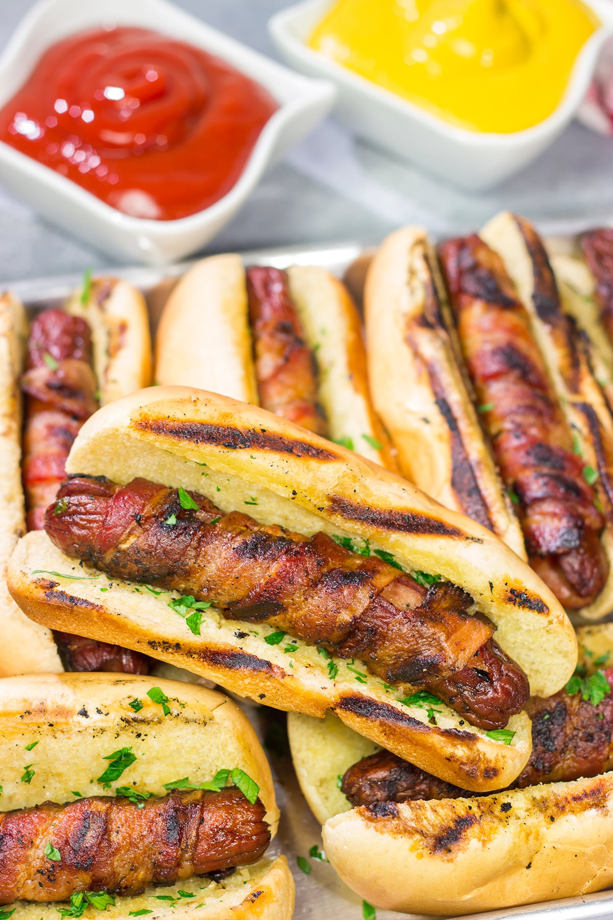 Holy hot dogs, Batman! No need for the oven here. These Grilled Bacon Wrapped Hot Dogs are cooked on the grill and served on a garlic bread buns. Yum!
