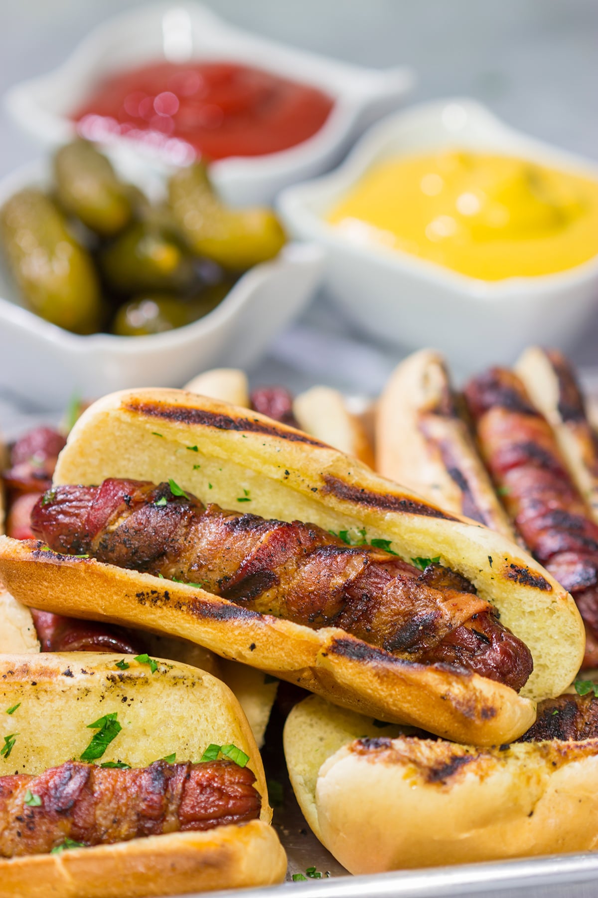 Holy hot dogs, Batman! No need for the oven here. These Grilled Bacon Wrapped Hot Dogs are cooked on the grill and served on a garlic bread buns. Yum!